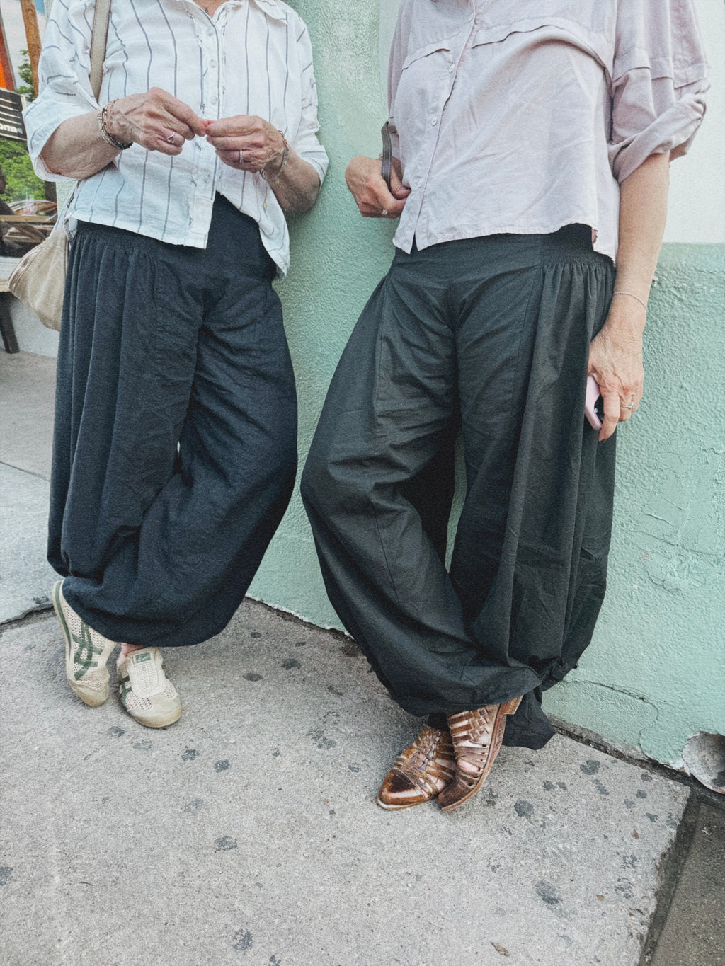 Two women wearing the Italian Pants with The Ease Tee.
