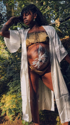 Pregnant and postpartum mom wearing the almost floor-length Ritual Robe (ivory) and Frolic Set in Cedar Smoke,  a luxury plant-dyed 100% silk set.
