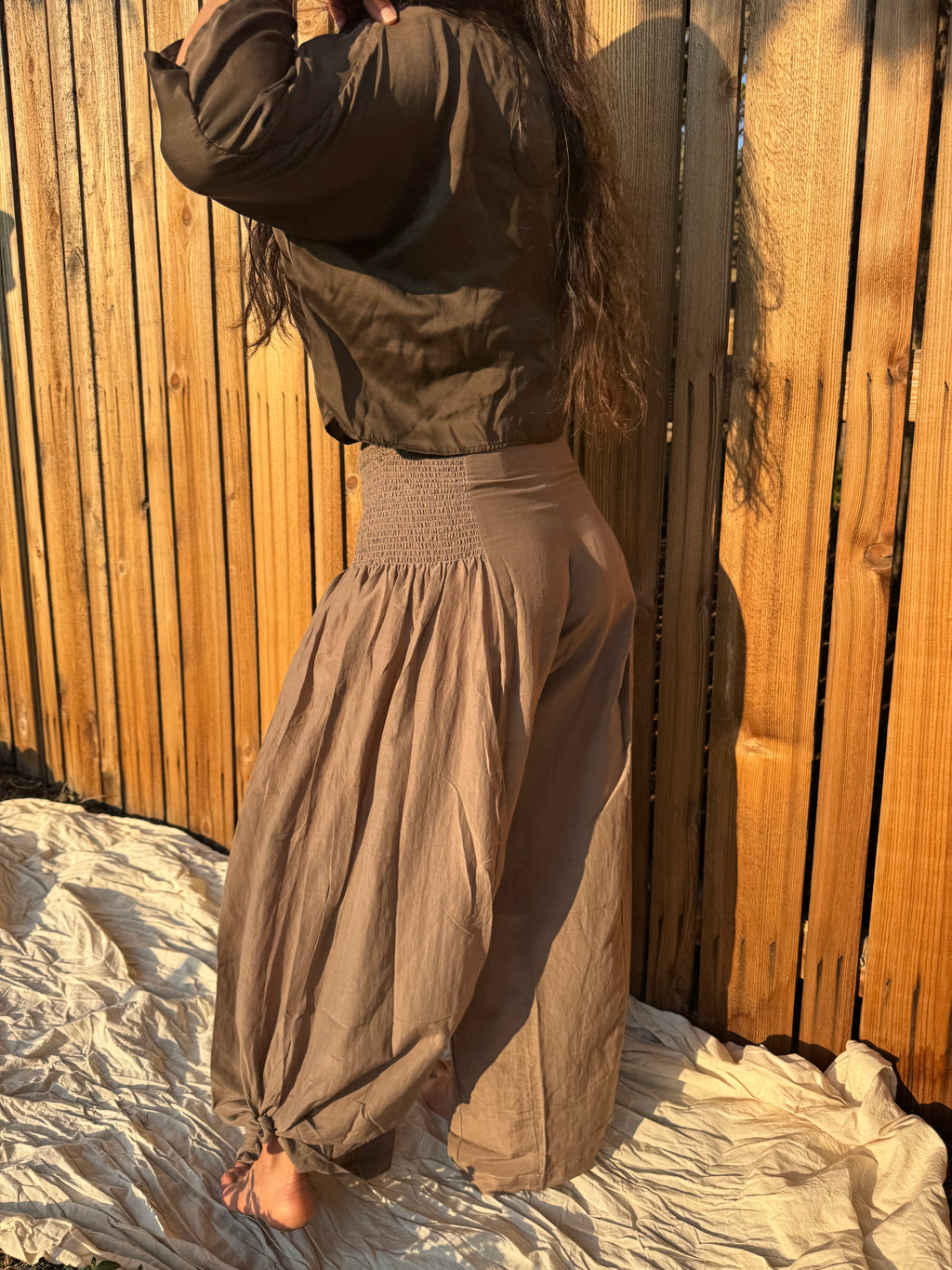 Side view of the Italian Pants showing their relaxed wide-leg silhouette.